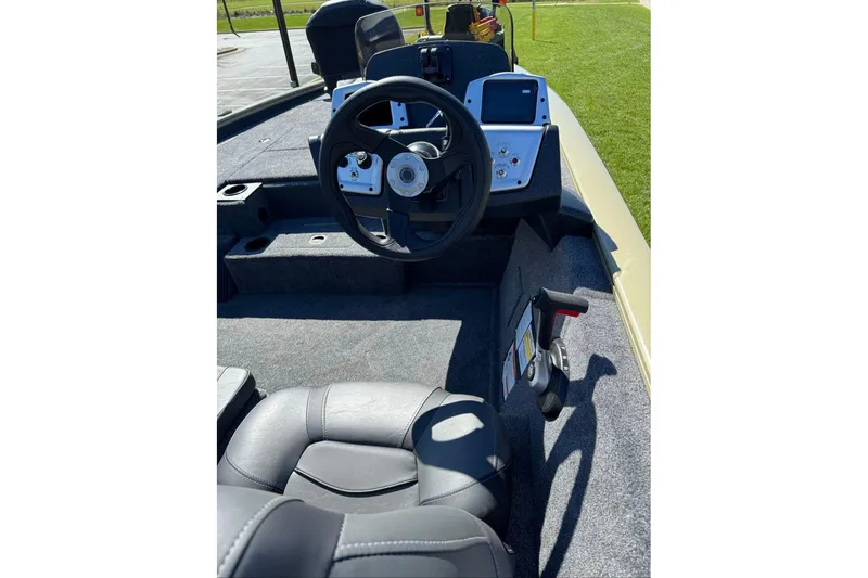 Slide: The Image of Interior view of 2026 Tracker Pro Team 195 boat, featuring steering wheel and control panel. - 10