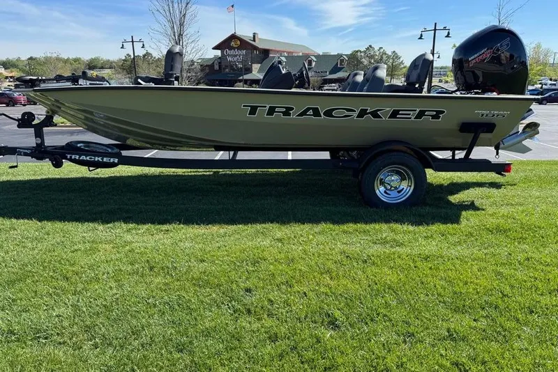 Slide: The Image of 2026 Tracker Pro Team 195 boat on trailer, parked on grass near Outdoor World. - 5