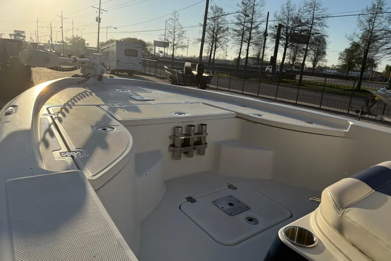 Slide: The Image of 2006 Triton 240 LTS boat interior, featuring spacious deck and seating, under a clear sky. - 14