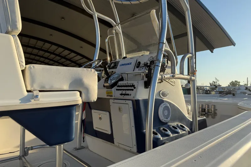 Slide: The Image of 2006 Triton 240 LTS boat interior with control panel and seating. - 8