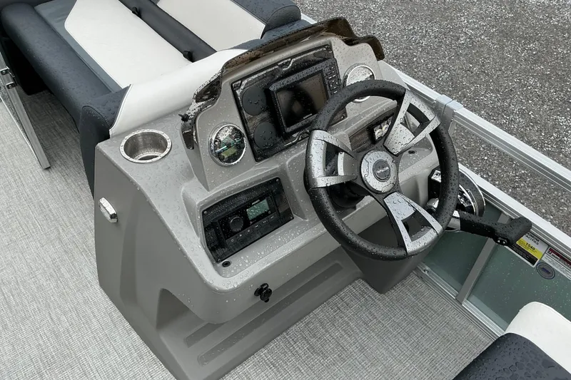 Slide: The Image of Steering console of 2026 Avalon Venture Quad Lounge 22' boat, featuring modern controls and design. - 6