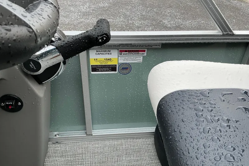 Slide: The Image of Close-up of Avalon Venture Quad Lounge 2026 boat interior with raindrops on seats. - 7