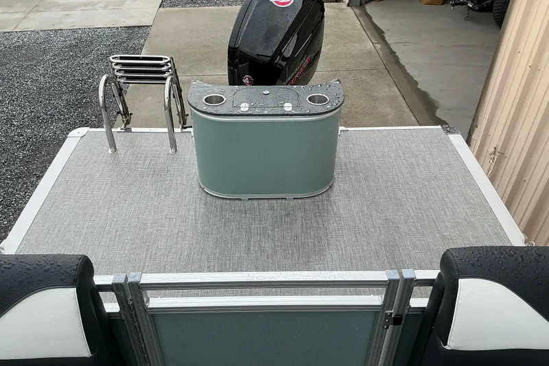 Slide: The Image of 2026 Avalon Venture Quad Lounge 22' boat deck with motor and seating area. - 8