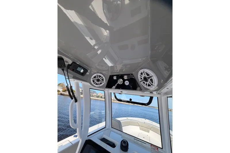 Slide: The Image of 2025 Sportsman Open 262 Center Console boat interior with seating and storage compartments. - 13