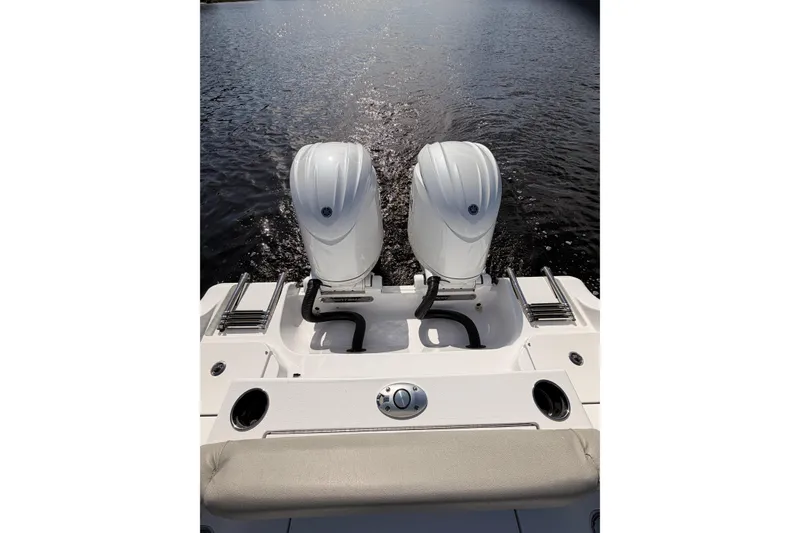 Slide: The Image of 2025 Sportsman Open 262 Center Console boat on calm water, featuring spacious seating. - 16