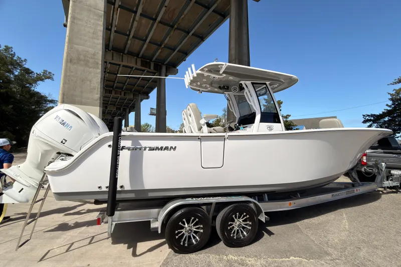 Slide: The Image of 2025 Sportsman Open 262 Center Console boat on trailer under bridge. - 6