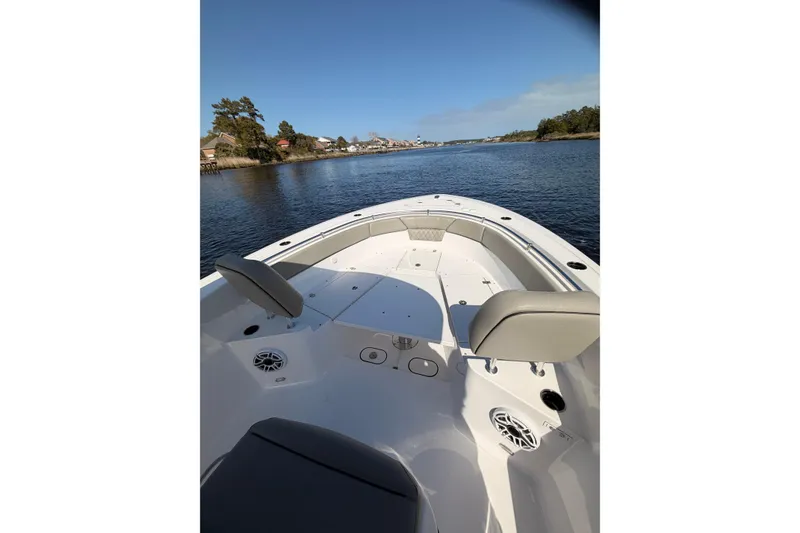 Slide: The Image of 2025 Sportsman Open 262 Center Console boat on calm water, featuring spacious seating. - 14
