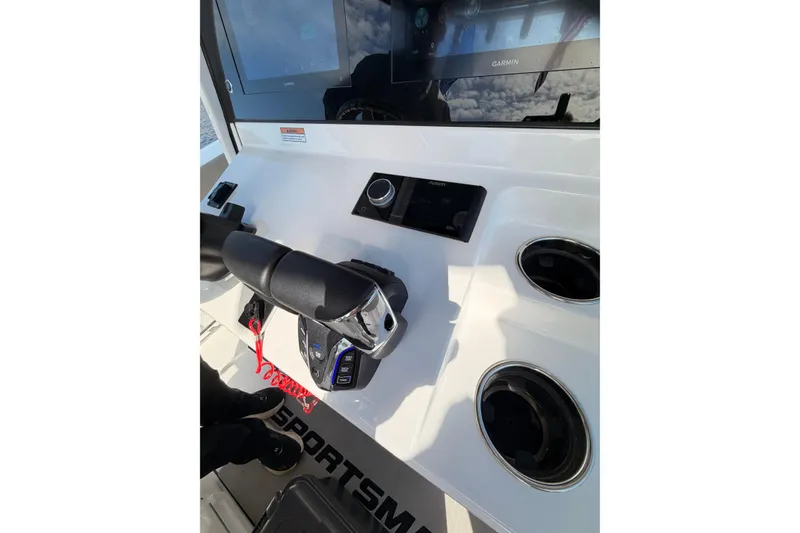 Slide: The Image of Center console of 2025 Sportsman Open 262 boat with controls and cup holders. - 21