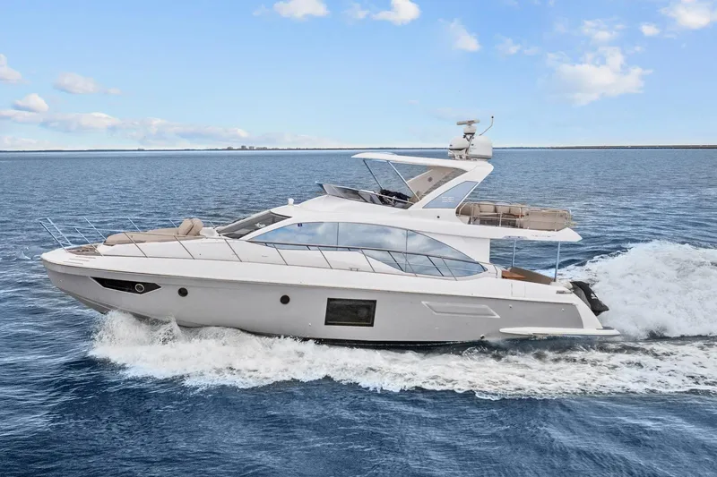 The Image of Luxury 2019 Azimut 55 yacht cruising on open water under a clear sky. - 0