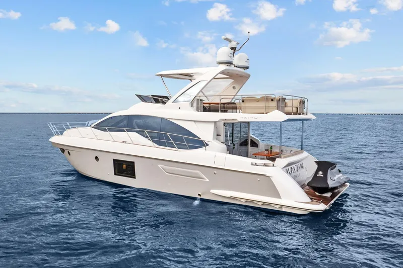 Slide: The Image of 2019 Azimut 55 yacht cruising on open water under a clear sky. - 10