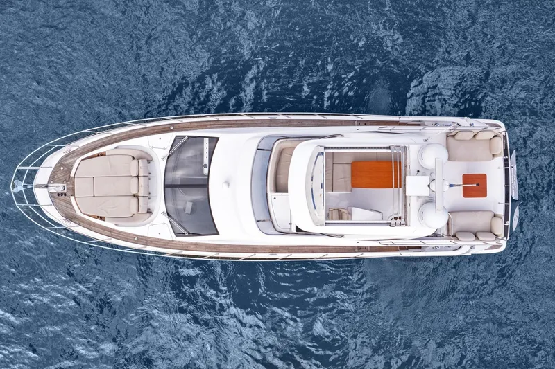Slide: The Image of Aerial view of 2019 Azimut 55 yacht on open water, showcasing sleek design and spacious deck. - 11