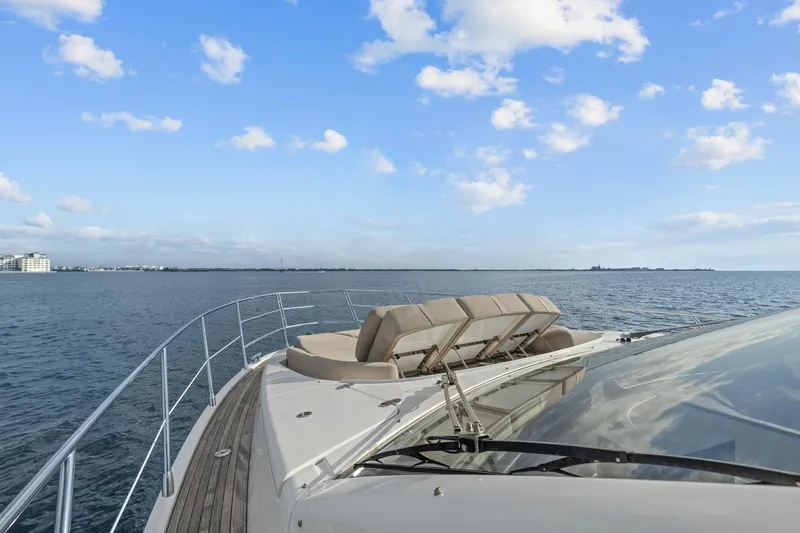 Slide: The Image of Luxury Azimut 55 yacht cruising on open water under a clear blue sky. - 13