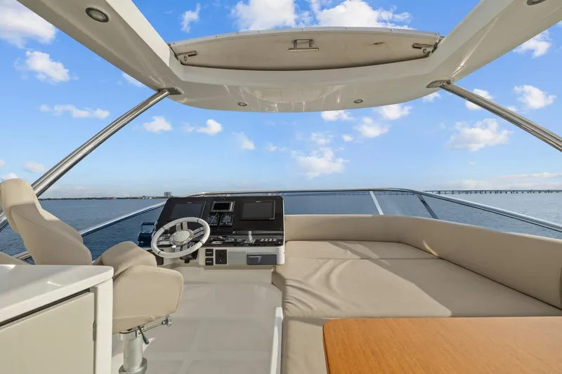 Slide: The Image of Flybridge of 2019 Azimut 55 yacht with helm, seating, and ocean view. - 15