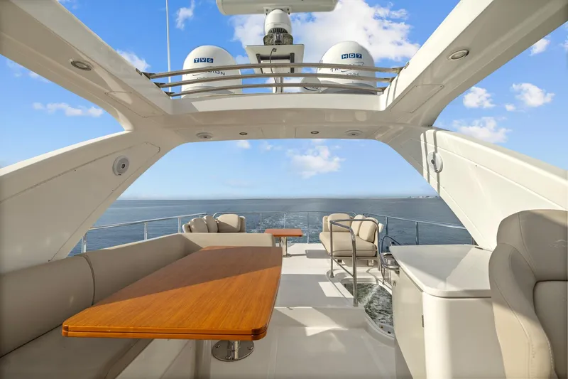 Slide: The Image of Luxurious 2019 Azimut 55 yacht deck with seating, table, and ocean view. - 16