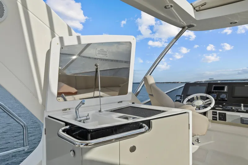 Slide: The Image of Luxury yacht Azimut 55 (2019) helm with sink and steering wheel, ocean view. - 18