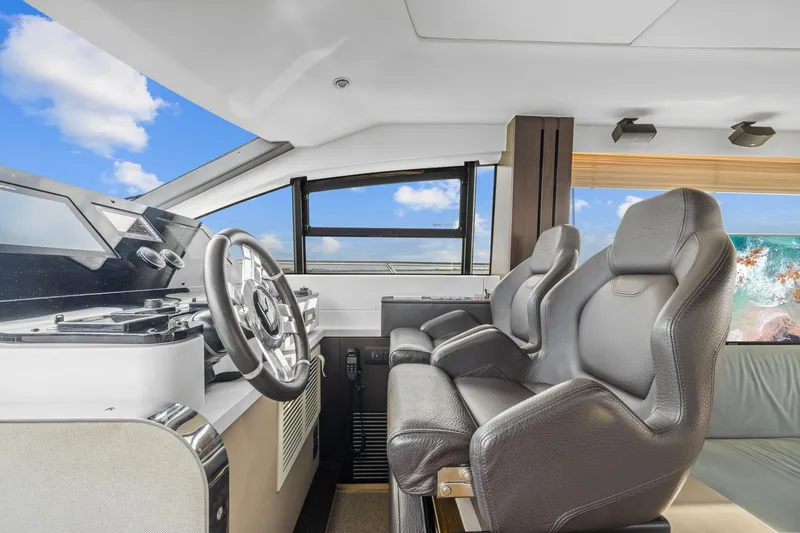 Slide: The Image of Interior cockpit of 2019 Azimut 55 yacht with modern steering and seating. - 26