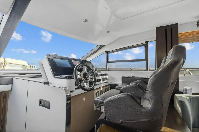 Slide: The Image of Luxurious 2019 Azimut 55 yacht helm with modern controls and panoramic windows. - 27