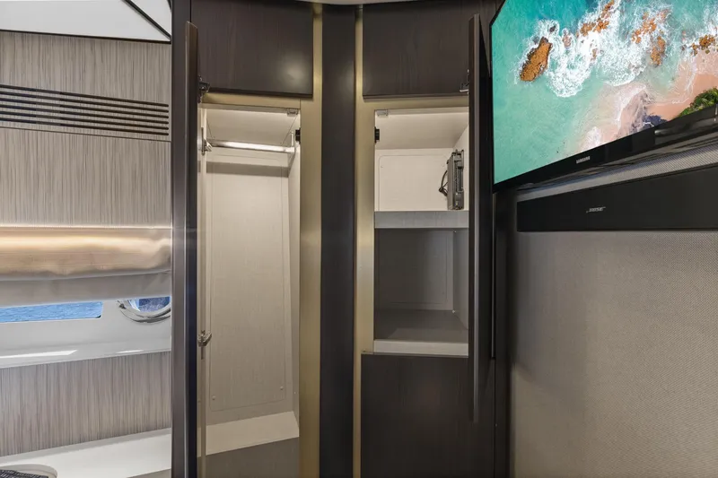 Slide: The Image of Interior of 2019 Azimut 55 yacht with open closet and mounted TV. - 30