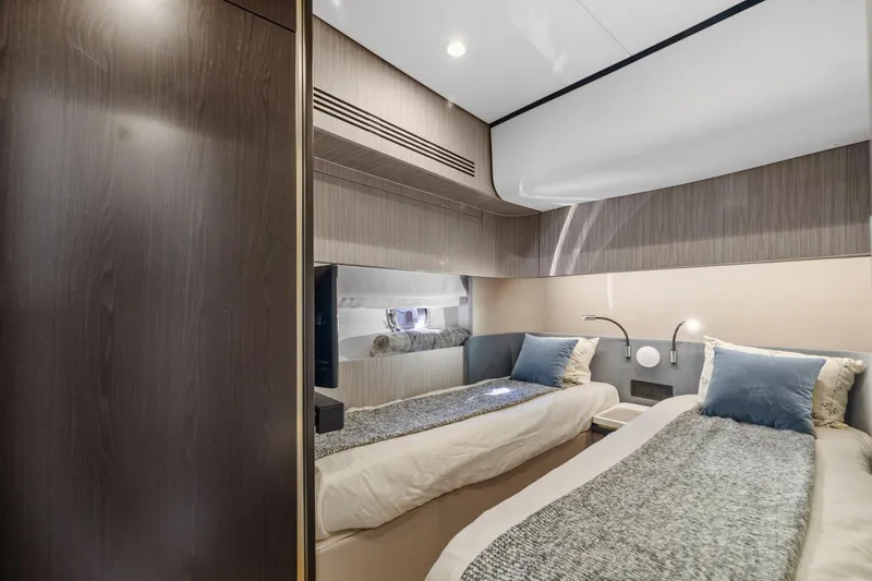 Slide: The Image of Luxurious 2019 Azimut 55 yacht cabin with twin beds and modern decor. - 32