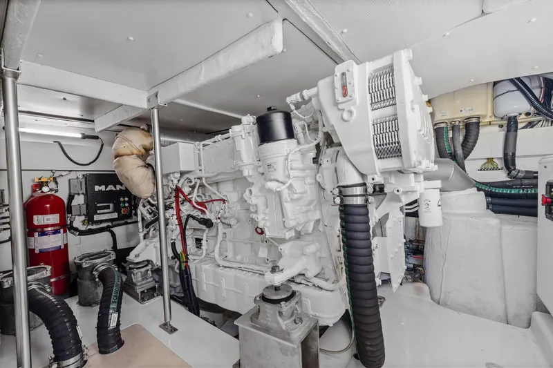 Slide: The Image of Engine room of a 2019 Azimut 55 yacht, featuring a MAN engine and fire safety equipment. - 39