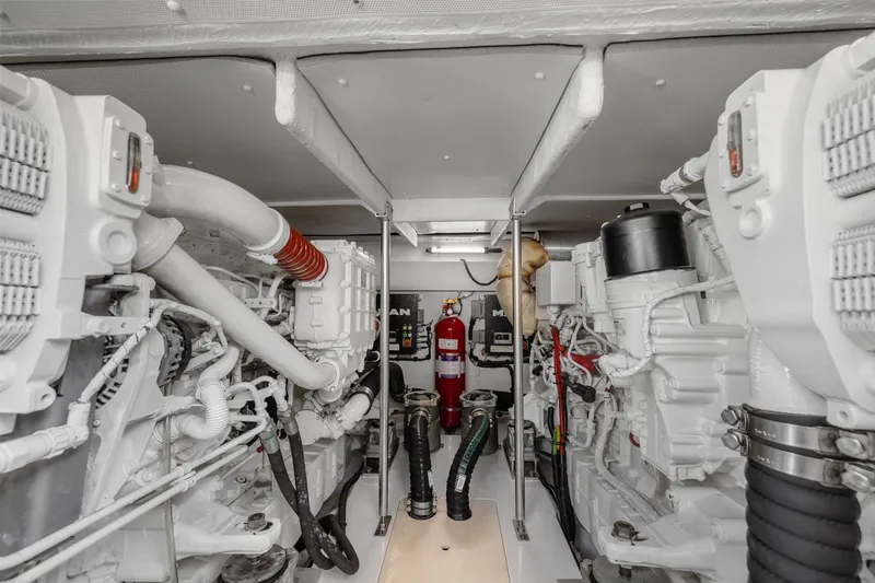 Slide: The Image of Engine room of a 2019 Azimut 55 yacht, featuring dual engines and fire suppression system. - 40