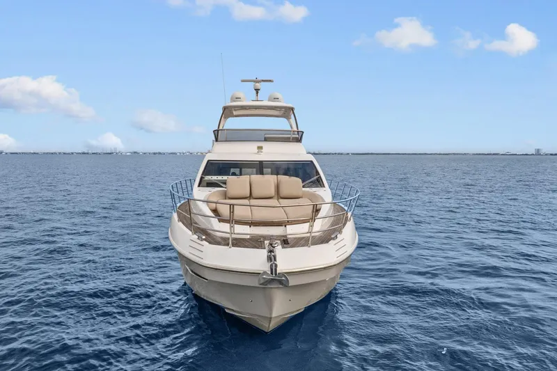 Slide: The Image of 2019 Azimut 55 yacht cruising on open sea under clear blue sky. - 5