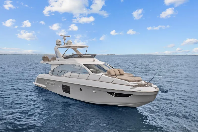 Slide: The Image of Luxurious 2019 Azimut 55 yacht cruising on open water under a clear blue sky. - 6