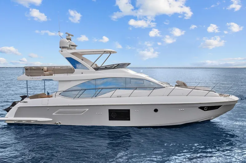 Slide: The Image of Luxury 2019 Azimut 55 yacht on calm ocean waters under a clear blue sky. - 7