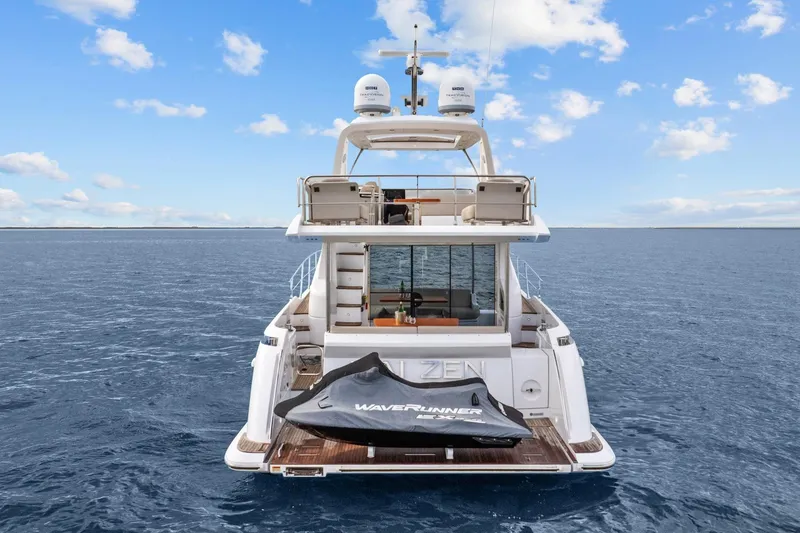 Slide: The Image of 2019 Azimut 55 yacht on open water with WaveRunner on deck. - 9