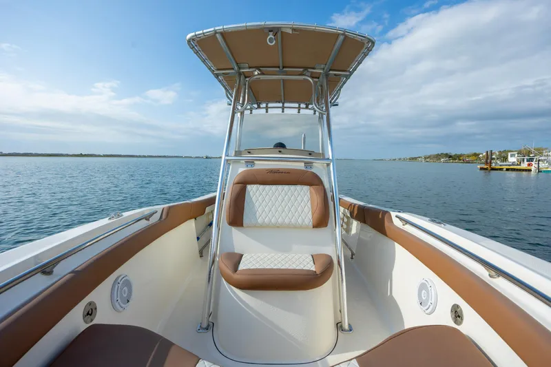 Slide: The Image of 2022 Pioneer 202 Islander boat on calm water, featuring tan and white seating. - 12