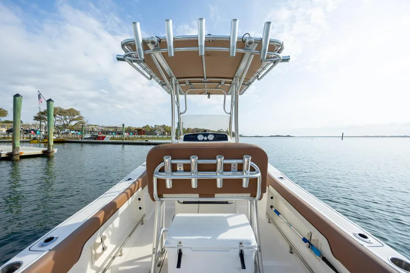 Slide: The Image of 2022 Pioneer 202 Islander boat docked, featuring a sleek design and spacious deck. - 16