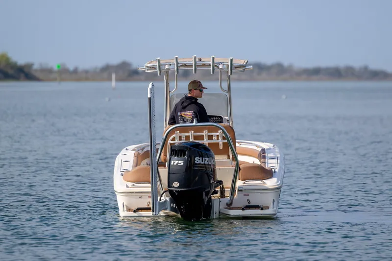 Slide: The Image of 2022 Pioneer 202 Islander boat with Suzuki engine on calm water. - 2