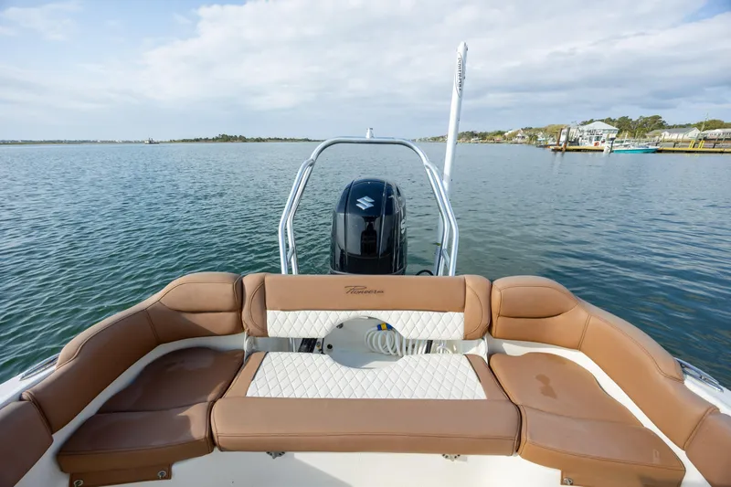Slide: The Image of 2022 Pioneer 202 Islander boat with tan seating, on calm water. - 20