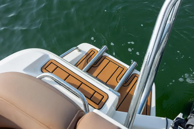 Slide: The Image of 2022 Pioneer 202 Islander boat swim platform with ladder in water. - 21
