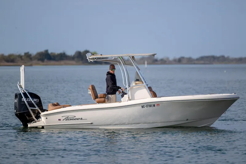 Slide: The Image of 2022 Pioneer 202 Islander boat on calm water with Suzuki outboard motor. - 4