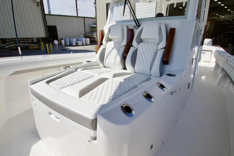 Slide: The Image of Luxurious white seats with gray accents on a boat, surrounded by stainless steel cup holders. - 14