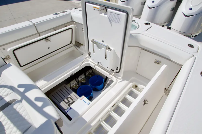 Slide: The Image of The image shows the cockpit of a Regulator 35 boat with storage and access hatches. - 32