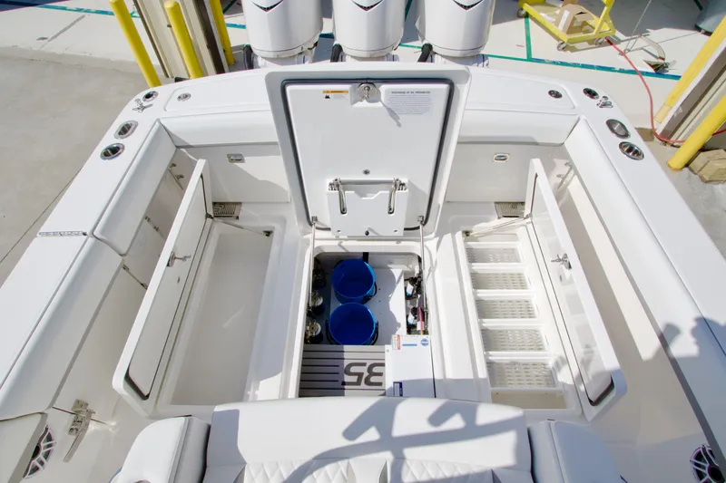 Slide: The Image of The image shows the stern of a Regulator 35 boat with storage compartments and engines. - 31