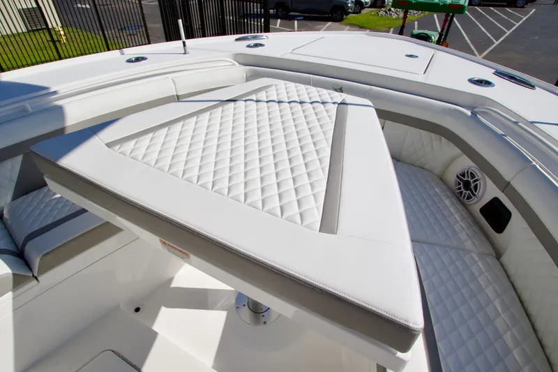 Slide: The Image of The image shows the bow area of a boat with cushioned seating and a table. - 16