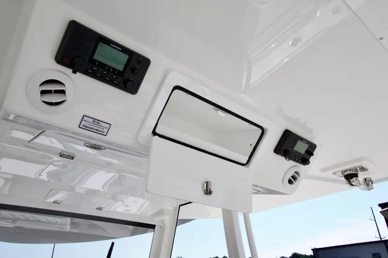 Slide: The Image of The image shows the cockpit of a Regulator 35 boat with electronic devices and storage. - 41
