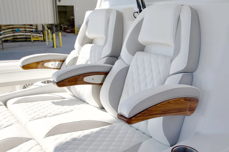 Slide: The Image of Luxurious padded seats with wooden armrests on a modern boat. - 17