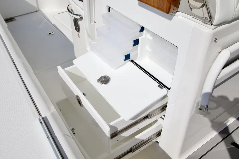 Slide: The Image of Regulator 35, 2027: White storage area with drawers and compartments on a boat. - 29