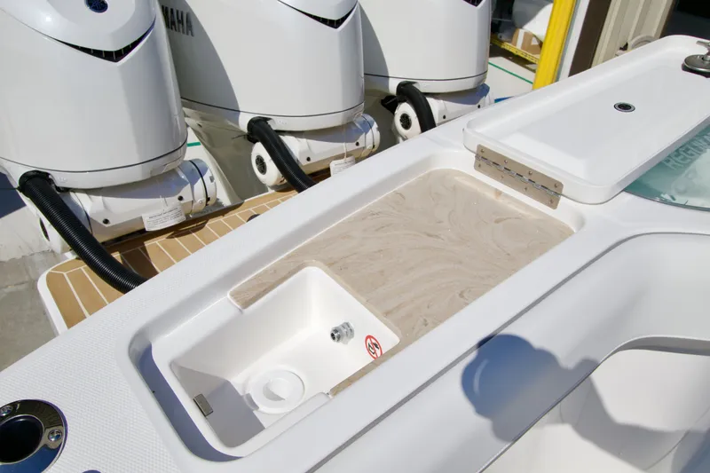 Slide: The Image of Close-up of a boat deck featuring a built-in sink and three outboard engines. - 39