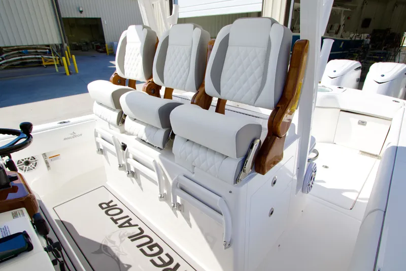 Slide: The Image of Three luxurious, cushioned seats on a boat with a white and gray design. - 24