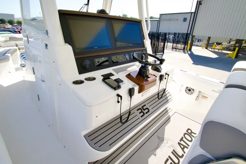 Slide: The Image of The image shows the cockpit of a Regulator 35 boat with modern electronics and controls. - 23