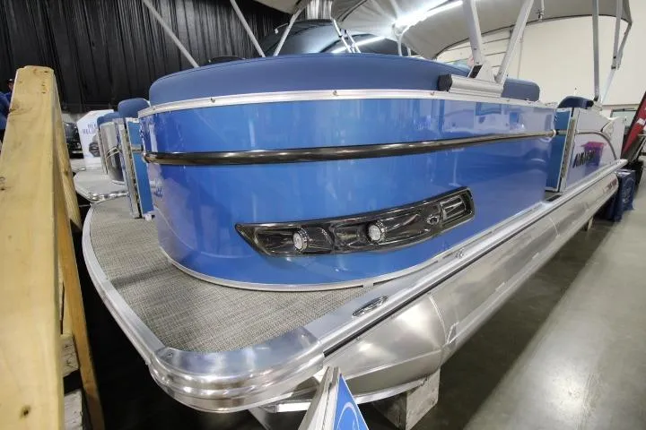 Slide: The Image of 2026 Avalon Catalina Versatile Rear Lounge pontoon boat, blue exterior, indoor display. - 2