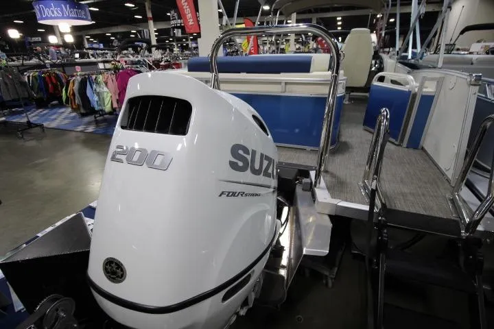 Slide: The Image of 2026 Avalon Catalina Versatile Rear Lounge boat with Suzuki 200 engine at a marine exhibition. - 4