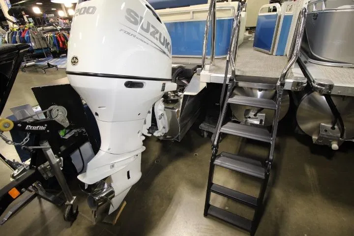 Slide: The Image of 2026 Avalon Catalina Versatile Rear Lounge boat with Suzuki outboard motor and boarding ladder. - 5