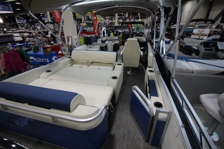 Slide: The Image of 2026 Avalon Catalina Versatile Rear Lounge boat interior with seating and helm, showcased indoors. - 7