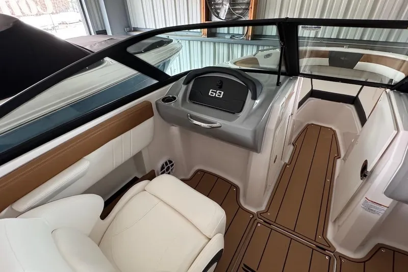 Slide: The Image of Interior of 2025 Chaparral 21 SSi OB boat, featuring sleek seating and modern dashboard. - 10